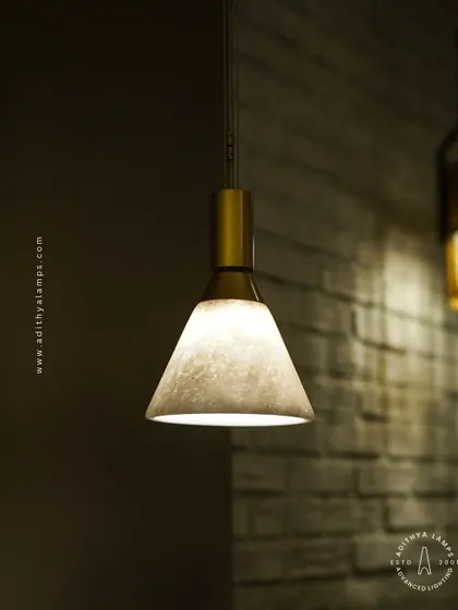 A simple yet elegant cone-shaped pendant light. The shade is crafted from marble, providing a warm, diffused downlight that is perfect for task lighting over kitchen counters, reading nooks, or as accent lighting.