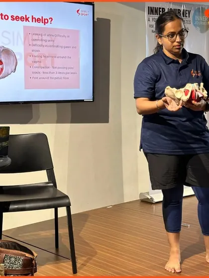 A facilitator holds up a pelvic model during our 'Simply Periods' workshop for elite Indian football athletes. Using anatomical models helps make the science of reproductive health clear and understandable.