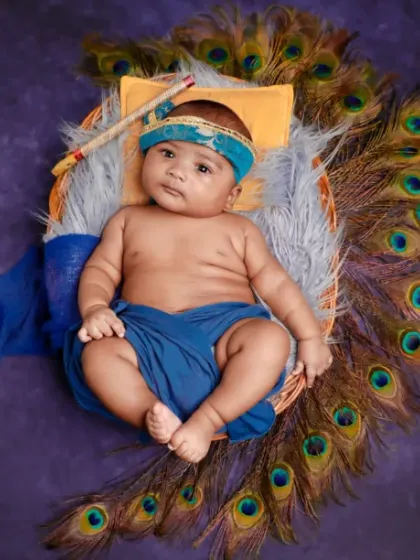 A little blessing. This Krishna-themed photoshoot is a beautiful way to celebrate your new arrival, complete with traditional colors and peacock feathers.