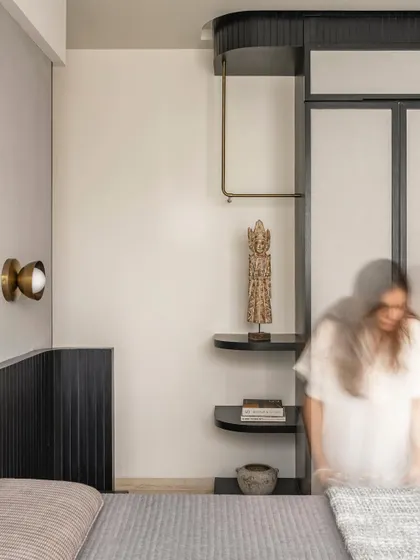 The second bedroom in Apartment 3201 features a masculine palette of black and grey, offset by brass details and found artifacts. The design creates a mood of stately calm with modern, minimal details.