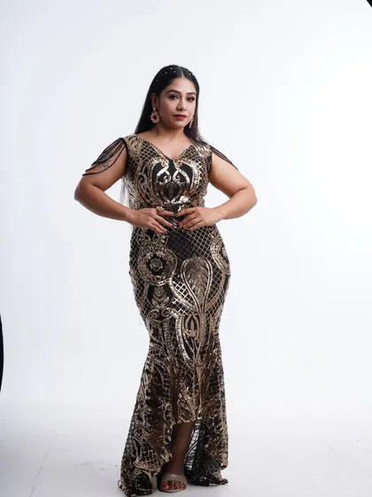 A confident pose in the black and gold sequin gown, perfect for showing off your style at a party or photoshoot.