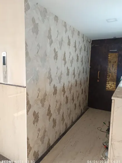 A beautiful damask-style wallpaper with a subtle texture, installed in a client's entryway. It creates a welcoming and elegant first impression.