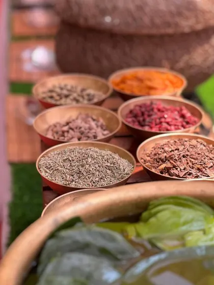 A traditional live paan station, with all the authentic ingredients laid out in brass bowls for a classic post-meal refreshment.