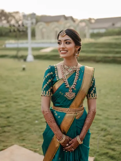 A radiant bride in her teal Kanjeevaram saree. We love capturing the vibrant colors and rich traditions of South Indian weddings.