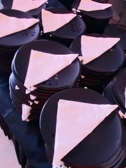 Simple, elegant, and practical. We use classic black plates with neatly folded white napkins for a modern and clean look that suits any corporate or private event.