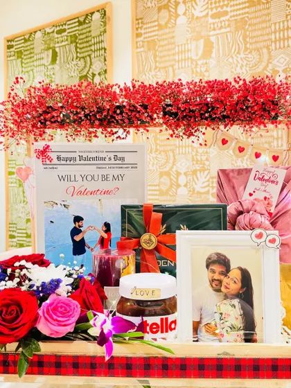 This is more than a gift, it's a grand romantic gesture. I designed this Valentine's hamper for him with a stunning arch of red gypsy flowers, a personalized 'love newspaper' sharing their story, and a curated selection of grooming essentials and gourmet treats.