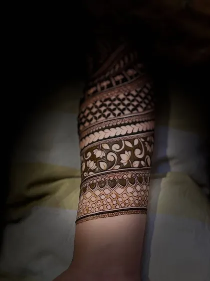 A full-sleeve design with spiraling bands of different patterns, creating a unique and dynamic look.