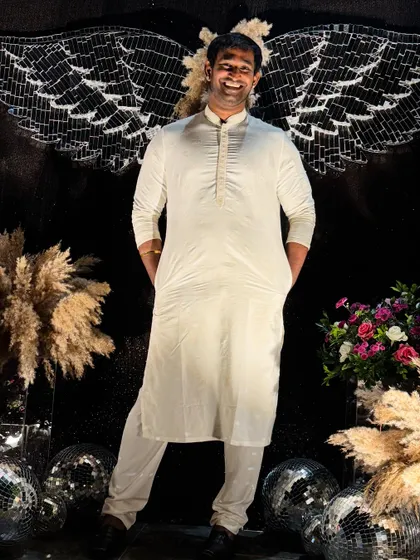 Posing with a creative angel-wing backdrop. I love when events have unique and fun photo opportunities.