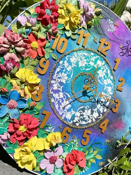 Another view of the large galaxy clock, set against a natural green background to highlight its vibrant colors.