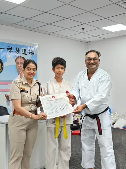 This student's focus and practice have earned him a yellow belt. Each step on the path of karate builds not just skill, but also character and self-discipline.
