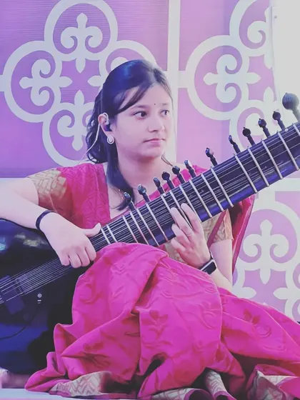 My student Pratiksha performing at a concert. Through regular baithaks and stage shows, students gain the confidence to share their music with an audience.