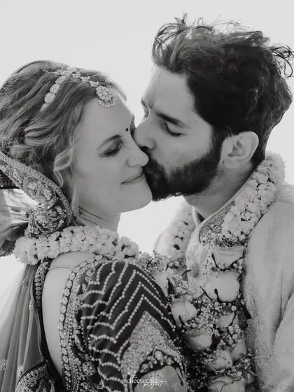 A sweet kiss on the cheek, captured in timeless black and white.