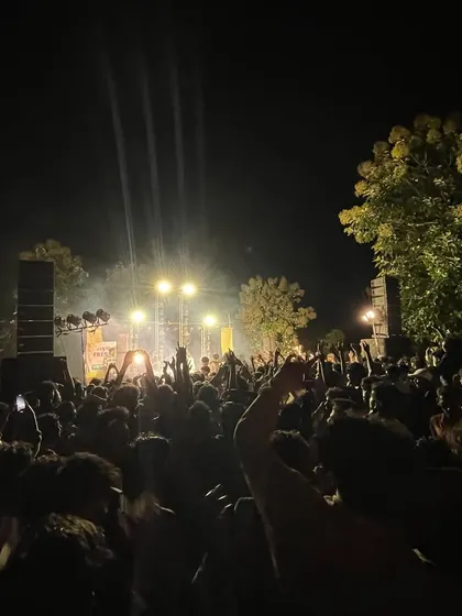The view of the massive crowd at a Palakkad college show, with the stage lights illuminating the night.
