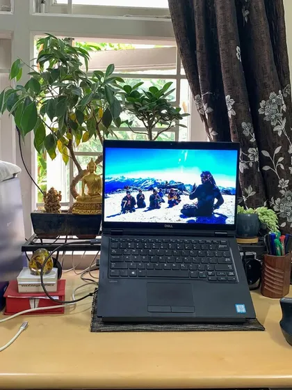 My workspace as a Karma Yogi. My laptop displays a picture of my students in the Himalayas, a constant reminder of my purpose and the community I serve.