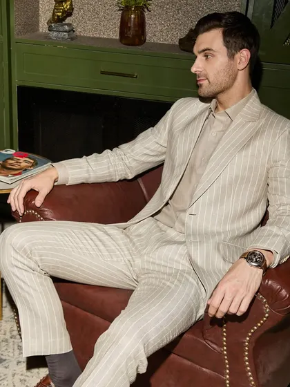 This pinstripe suit, crafted from breathable Irish linen, exudes quiet power. The structure and silhouette are designed to own the room, not overpower it. It's a perfect example of how I blend classic patterns with modern fabrics for a timeless look.