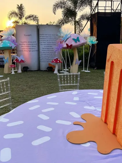 A quirky popsicle centerpiece for a fun 'Candyland' themed birthday party, with a custom-printed sprinkle tablecloth.