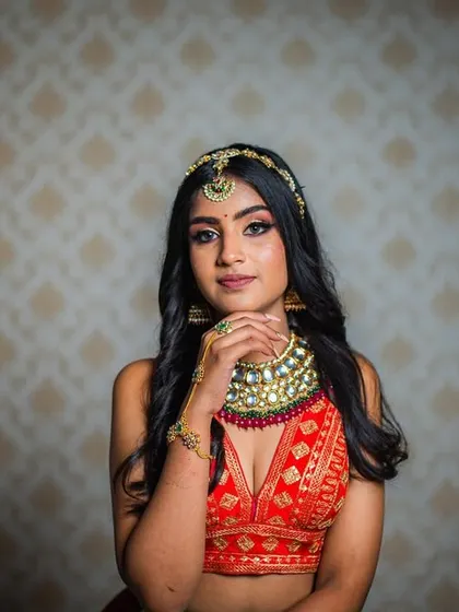A striking portrait that captures a modern yet traditional essence. The kundan jewellery and sharp makeup create a captivating look.