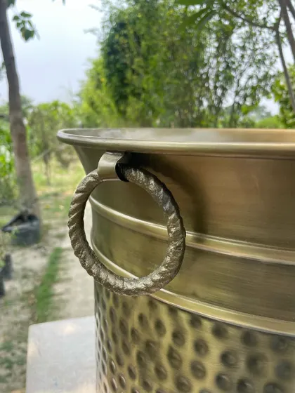 A close-up of the twisted ring handle on our antique brass planter. It's these small, handcrafted details that make our custom pots so special.