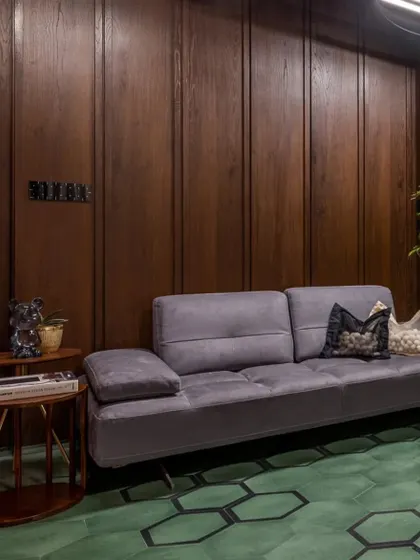 For this lounge room, the brief was "moody but fun." We achieved this with rich green hexagonal floor tiles from Bharat Floorings and dark wood paneling, creating a cozy den-like feel.
