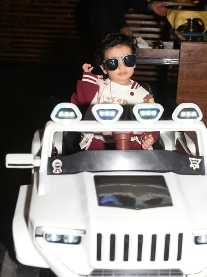 The little man means business! A fun shot of the birthday boy in sunglasses, looking like a star in his ride-on toy car.