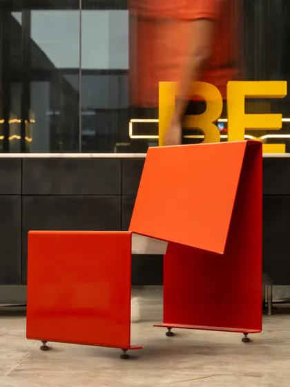 The chair's form captured in motion, emphasizing its dynamic yet simple profile. It is a piece of furniture designed for life and movement, durable enough for any environment while maintaining its minimalist aesthetic.