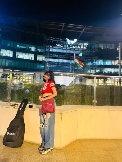 Standing outside Worldmark, Aerocity with my guitar case after a day of music. Being a gigging musician in the city is an adventure.