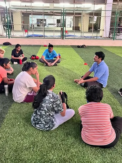 A close-up of our coach leading a group discussion on the training ground. We cover everything from fight analysis to goal setting.
