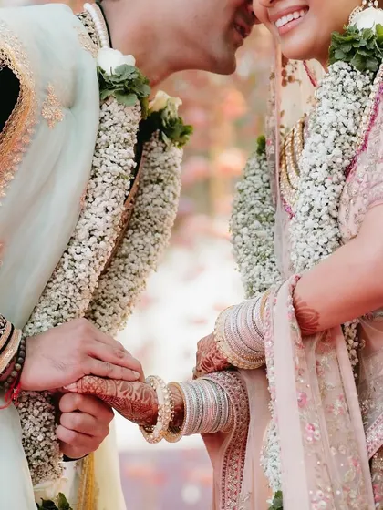 An intimate close-up of the couple during their varmala ceremony. Beyond the grand decor, we focus on creating the moments of connection and emotion that are the true heart of any wedding.