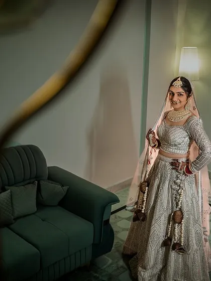 A vision in white. This bride's stunning white lehenga is perfectly captured in this elegant getting-ready portrait.