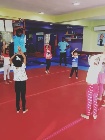 Our "Good Friends" class participating in the "Number Tumblers" theme. These images show the group learning advanced math and tumbling skills through warm-ups, stretches, and games.