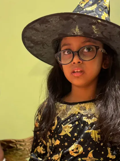 A little witch in her pointed hat and glasses, looking on with curiosity. Every costume tells a story, and I love seeing them all.