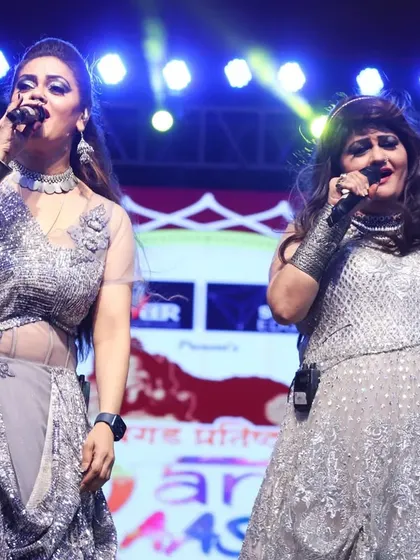 A powerful shot of us singing a duet during the Navratri festival. The energy between us on stage is electric.