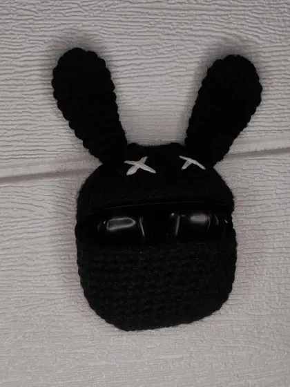 The bunny AirPods case in action, keeping your earbuds safe and sound inside its crocheted belly.