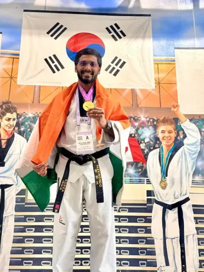 A proud moment with my medal and the Indian flag at the World Taekwondo event.
