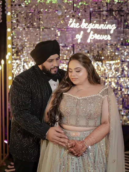A romantic shot of the couple. The bride's hair looks stunning against the sparkling backdrop.