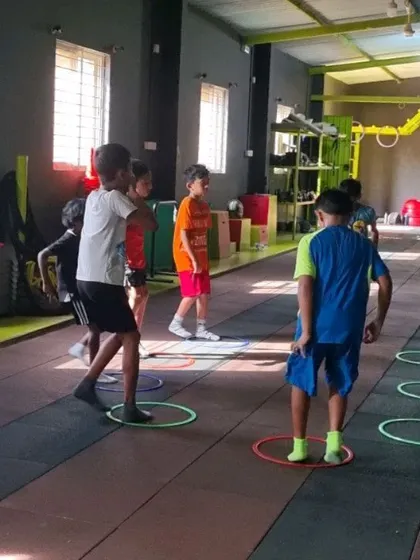 Kids participating in a group fitness game using agility rings. Making fitness fun is key to keeping them engaged.
