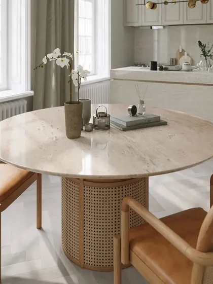 The Siena Dining Table in a bright, modern kitchen setting. The natural travertine stone top and rattan-wrapped base bring a touch of organic texture and tropical elegance, making every meal feel special.