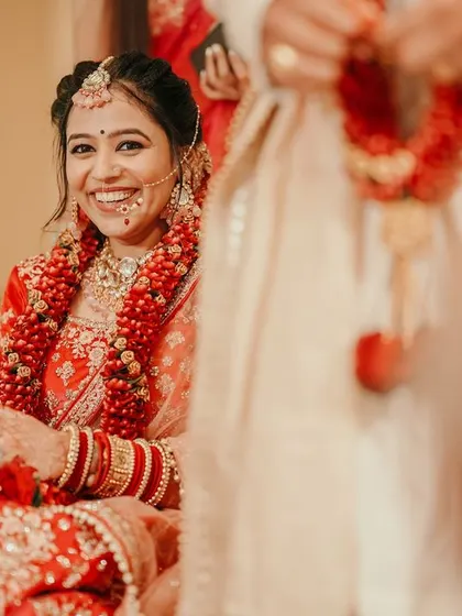 The bride's joyful smile during her wedding ceremony is perfectly captured in this candid shot.