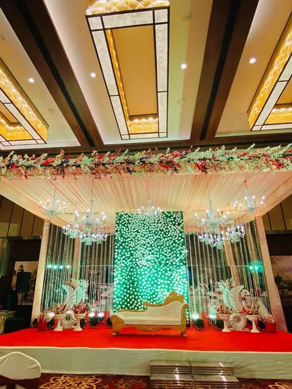 A full view of the indoor stage, showing the red carpet and the overall luxurious feel of the banquet hall.