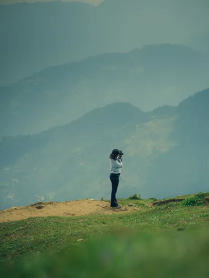 Standing on a meadow in Jalori Pass, taking in the vast landscape with my binoculars. Sometimes it's important to just stop and observe before you start shooting.