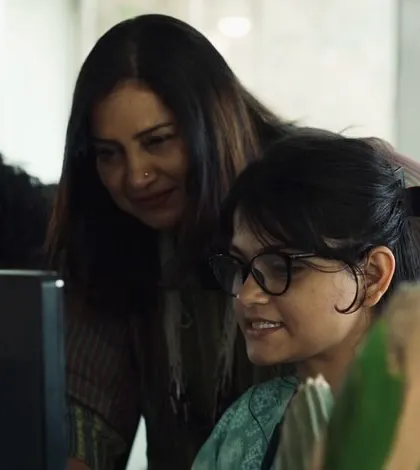 Mentorship in action at a workstation.