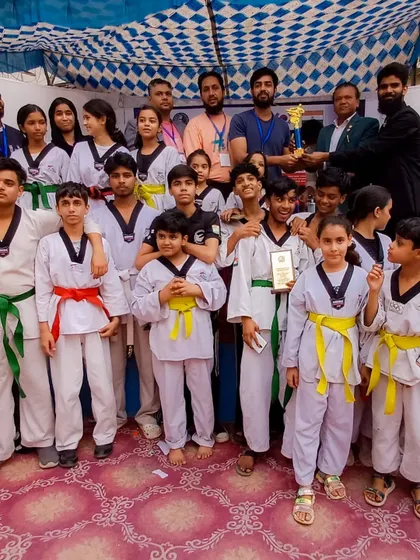 The team celebrates a group victory at the 1st Strike Inter-Club Taekwondo Tournament.