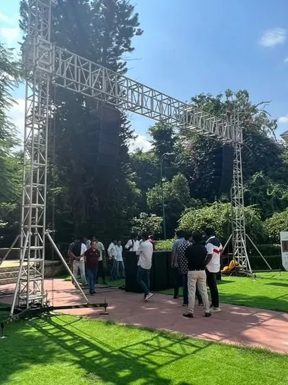 The entrance to an outdoor brand event, marked by a large truss structure. We build custom staging and rigging to define the event space and support lighting and sound equipment.
