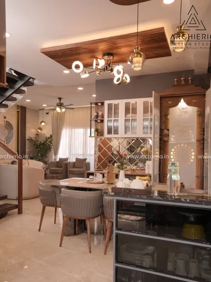 A dining area that exudes luxury with its unique table base and plush chairs. The space is designed for fine dining experiences right at home.