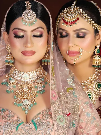 A moment of serene beauty. This image highlights the flawless eye makeup on both brides, from a neutral shimmer to a more dramatic smokey look.
