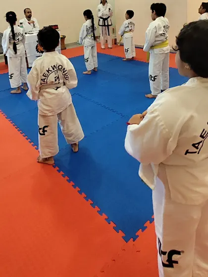 Our students line up for instruction, learning the importance of order and respect in the dojang.