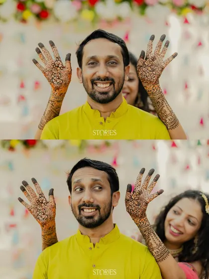 A fun and quirky Mehendi portrait, with the bride playfully placing her henna-covered hands behind the groom's head. Their animated expressions make for a memorable and candid shot.