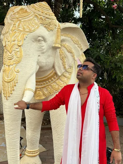 My red kurta and white scarf combo, posing next to a majestic elephant statue. A perfect look for a traditional Indian wedding ceremony.