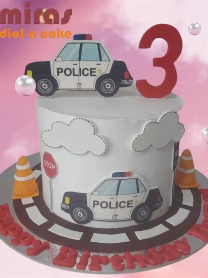 A fun police car cake for a little one's third birthday. The design features a road, traffic cones, and police car cutouts, making for a playful and exciting theme.