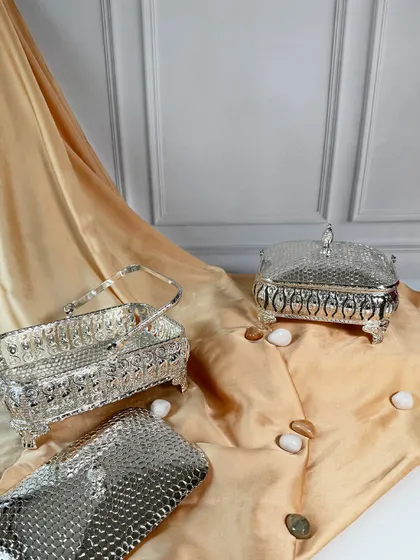The lids are removed to show the utility of these beautiful silver baskets. They are as practical for storage as they are elegant for display.
